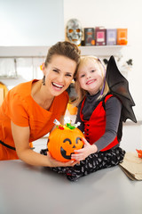 Wall Mural - Portrait of halloween dressed girl with mother and candy