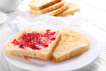 Wall Mural - Bread with homemade jam in plate on wooden table, closeup