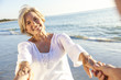 © Darren Baker - Happy Senior Couple Walking Holding Hands Tropical Beach