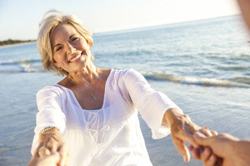 Happy Senior Couple Walking Holding Hands Tropical Beach