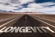 Longevity written on desert road