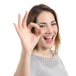 Close up of a happy woman making ok gesture