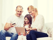 © Syda Productions - parents and girl with tablet pc and credit card
