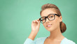 © Syda Productions - happy teenage student girl or woman in eyeglasses