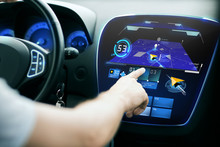 Male Hand Using Navigation System On Car Dashboard