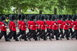 Queen's foot guards marching in formation down The Mall in a royal Trooping the Colour ceremony in London England