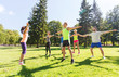 © Syda Productions - group of happy friends exercising outdoors