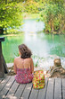 © runlenarun - Travel woman enjoying beautiful lake. Lonely  young girl sitting