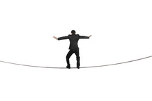 Rear View Of Businessman Balancing On Tightrope