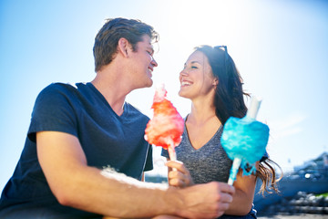 Wall Mural - romantic couple on date on sunny summer day with cotton candy