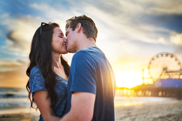 romantic couple kissing at santa monica