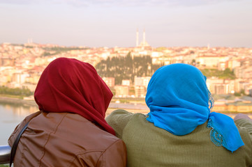 Two muslim women overlooking the panorama of Istanbul