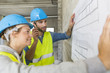 © Atelier 211 - Engineers on building site checking plans