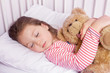 © Myst - cute little girl sleeping with stuffed toy in her bed