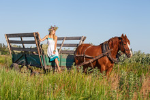 Pretty Girl With Wildflowers On The Horse Carriage In Summer Day