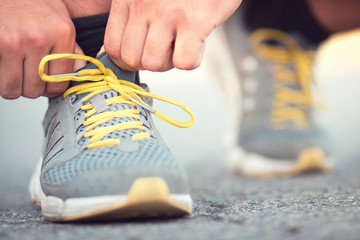 Runner tying shoelaces on sneakers