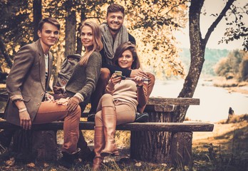 Cheerful friends in autumn park