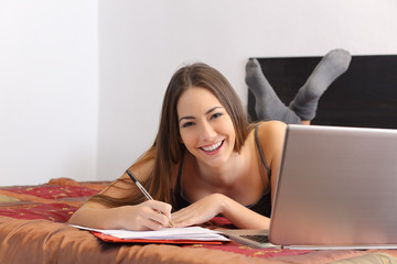 Sticker - Happy student studying with a laptop in her bedroom