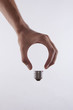 abstract conceptual image of a male's hand holding a light bulb