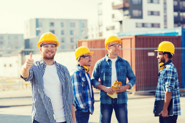 Wall Mural - group of smiling builders in hardhats outdoors