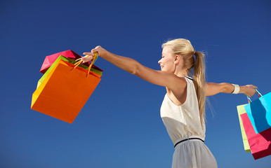 Poster - smiling woman with shopping bag rising hands