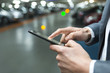 © ldprod - In parking car a man using his mobile phone.  Light bokeh background