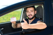 © W PRODUCTION - happy young successful man showing his new european driving license