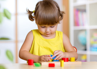 child plays with colorful education toy