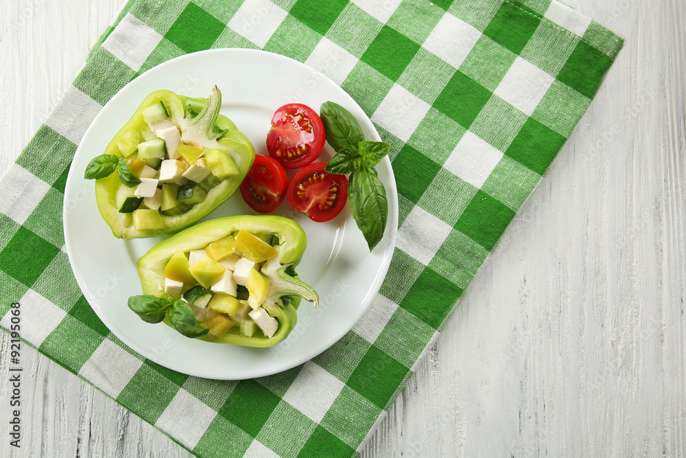 Fresh green salad in pepper on table close up