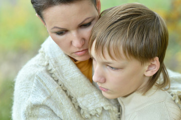 Sad mother with son in park