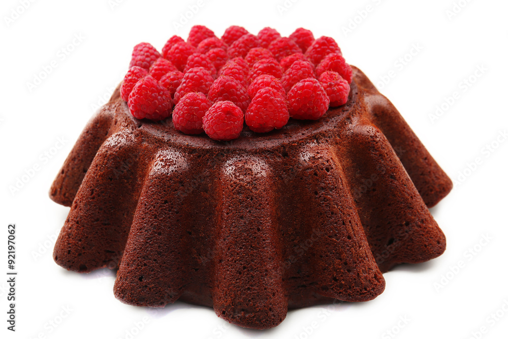 Tasty chocolate muffin with raspberries isolated on white