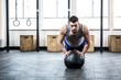 © Wavebreak Media - Fit man working out with ball