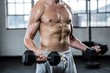 © Wavebreak Media - Fit shirtless man lifting dumbbells