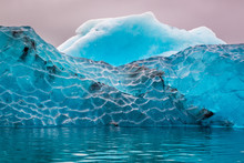 Blue Iceberg In Cold Lake, Iceland