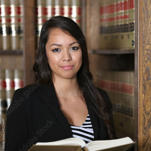 Portrait of Young Attractive Hispanic Female Lawyer in Law Library