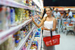 © vladstar - Young woman shopping for cereal, bulk in a grocery supermarket