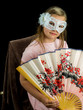 Girl with fan and mask in dress