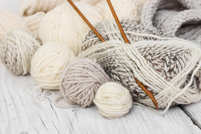 Skeins Of Wool Yarn And Knitting Needles
