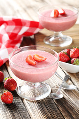 Poster - Tasty strawberry mousse in glass on brown wooden table