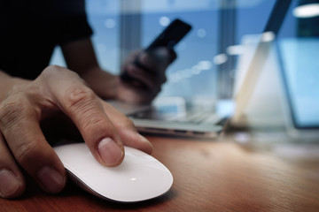 close up of business man hand working on laptop computer on wood