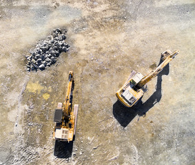 Canvas Print - Aerial view of working excavator in the opencast mine. Camera flight over industrial landscape.