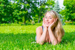 © kosmos111 - girl with a beautiful smile posing lying on the grass