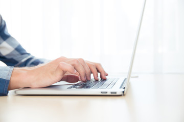 Male hands using laptop