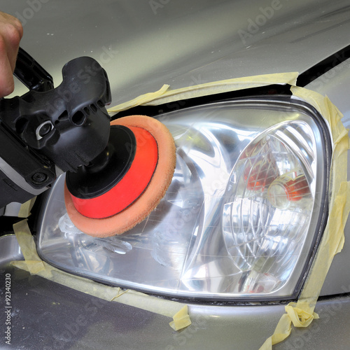 Fényképezés  Car light repairing, hand with tool polish headlight