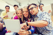 © Syda Productions - group of smiling students with tablet pc