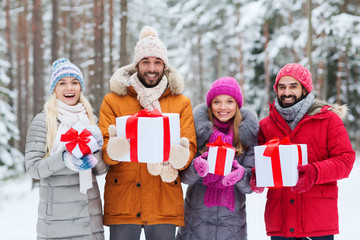 Wall Mural - happy friends with gift boxes in winter forest