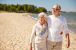 © Syda Productions - happy senior couple walking along summer beach