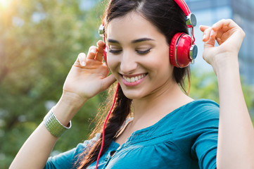 Wall Mural - woman listening to music and dancing
