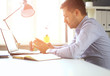 © opolja - businessman using smartphone and laptop