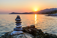 Turret Pebbles At Sunset With Ocean On Background. Relaxing Stones
